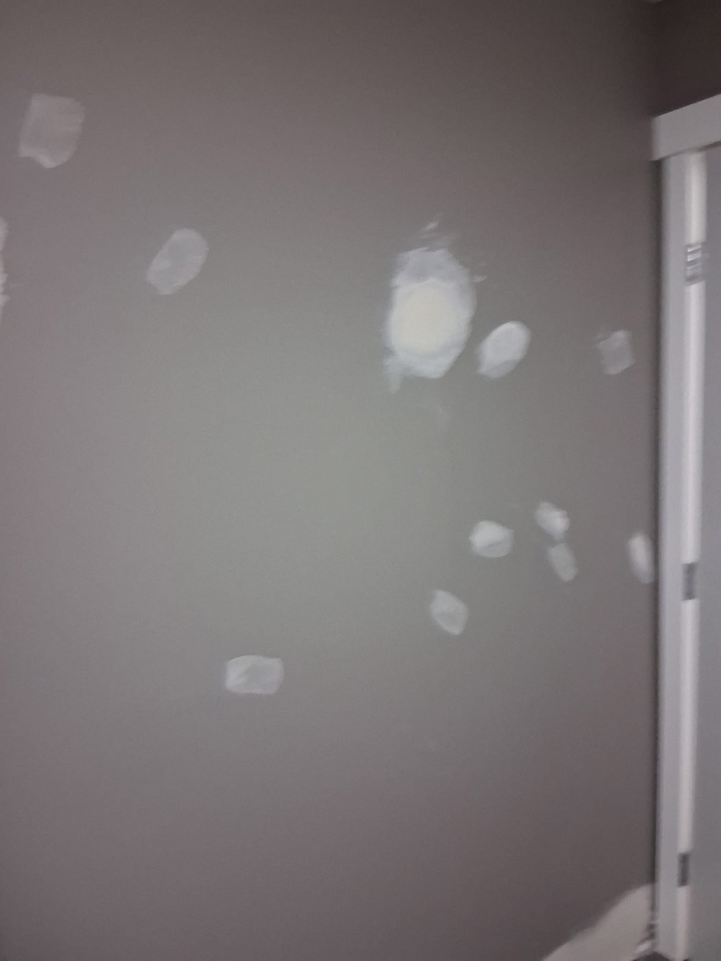 Bedroom wall filled in many places before sanding and painting
