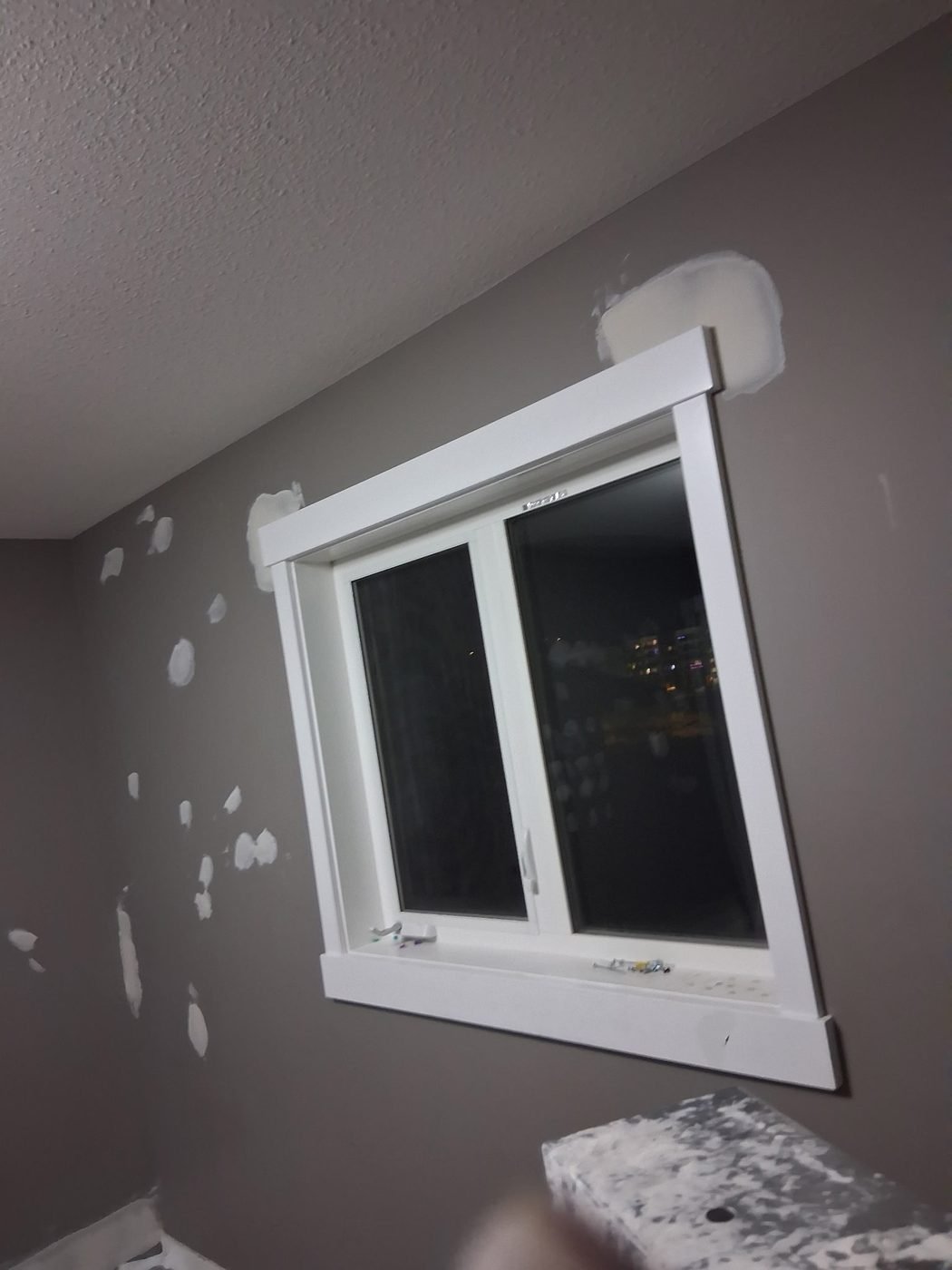Bedroom wall filled around a window with white trim