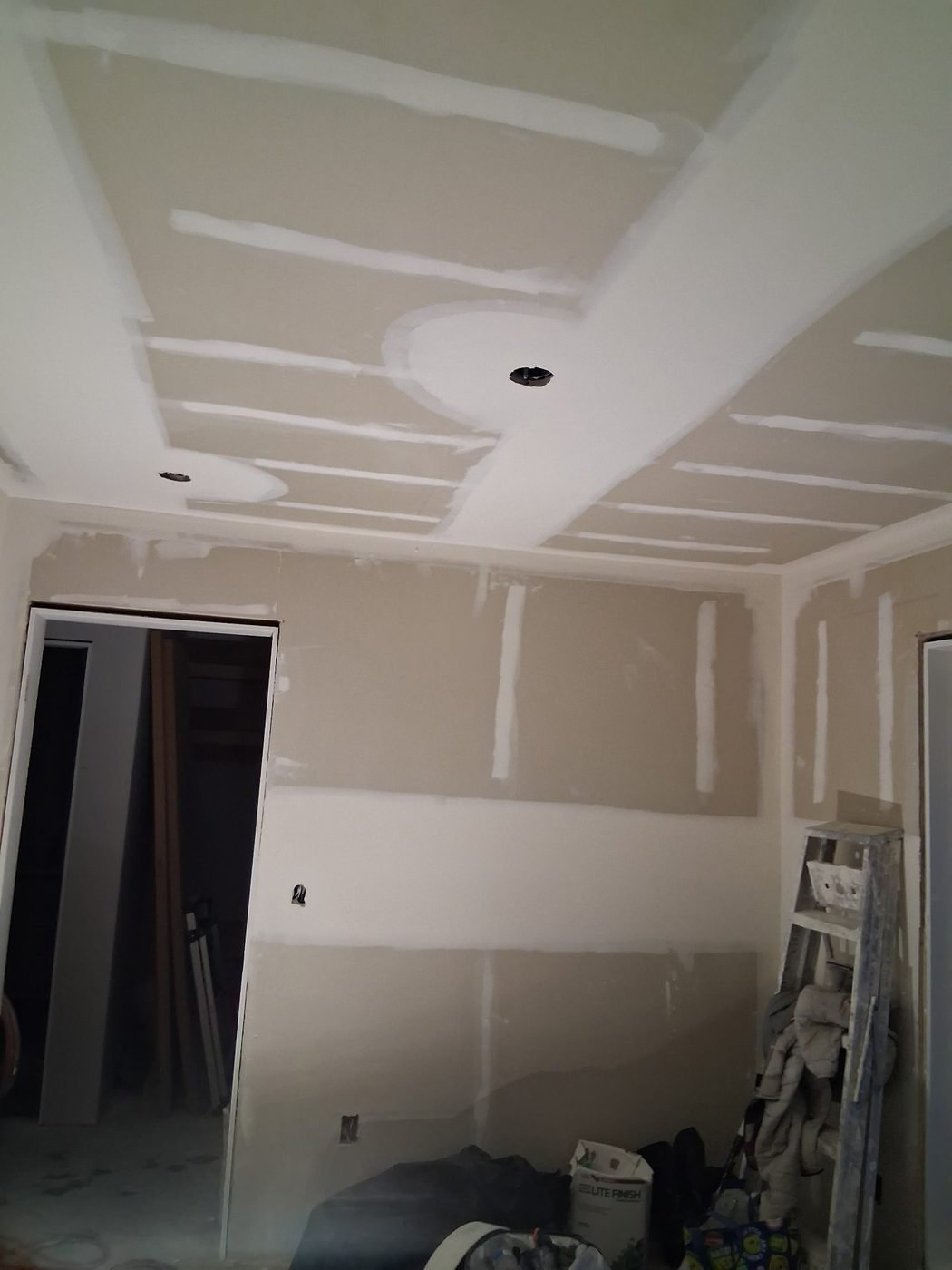 Taped ceiling and wall joints with pot light openings cut